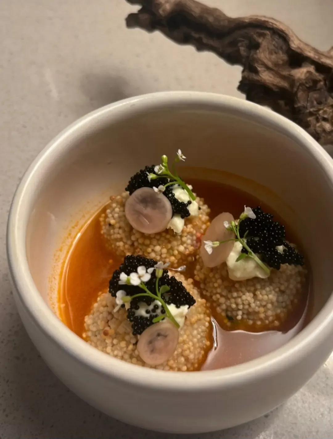 A small course in a white bowl on a pale counter